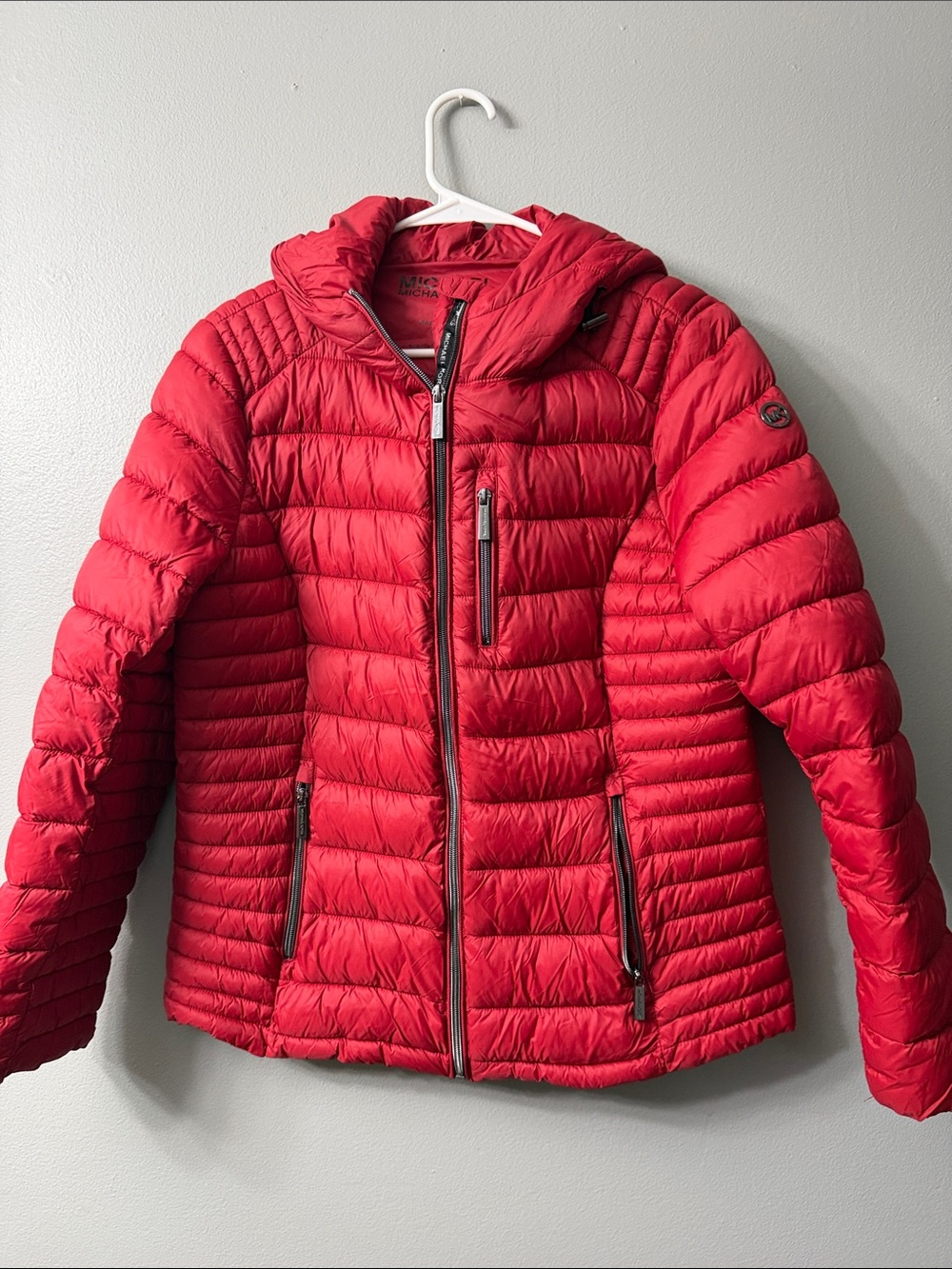 Michael Kors hooded packable puffer jacket in size large.